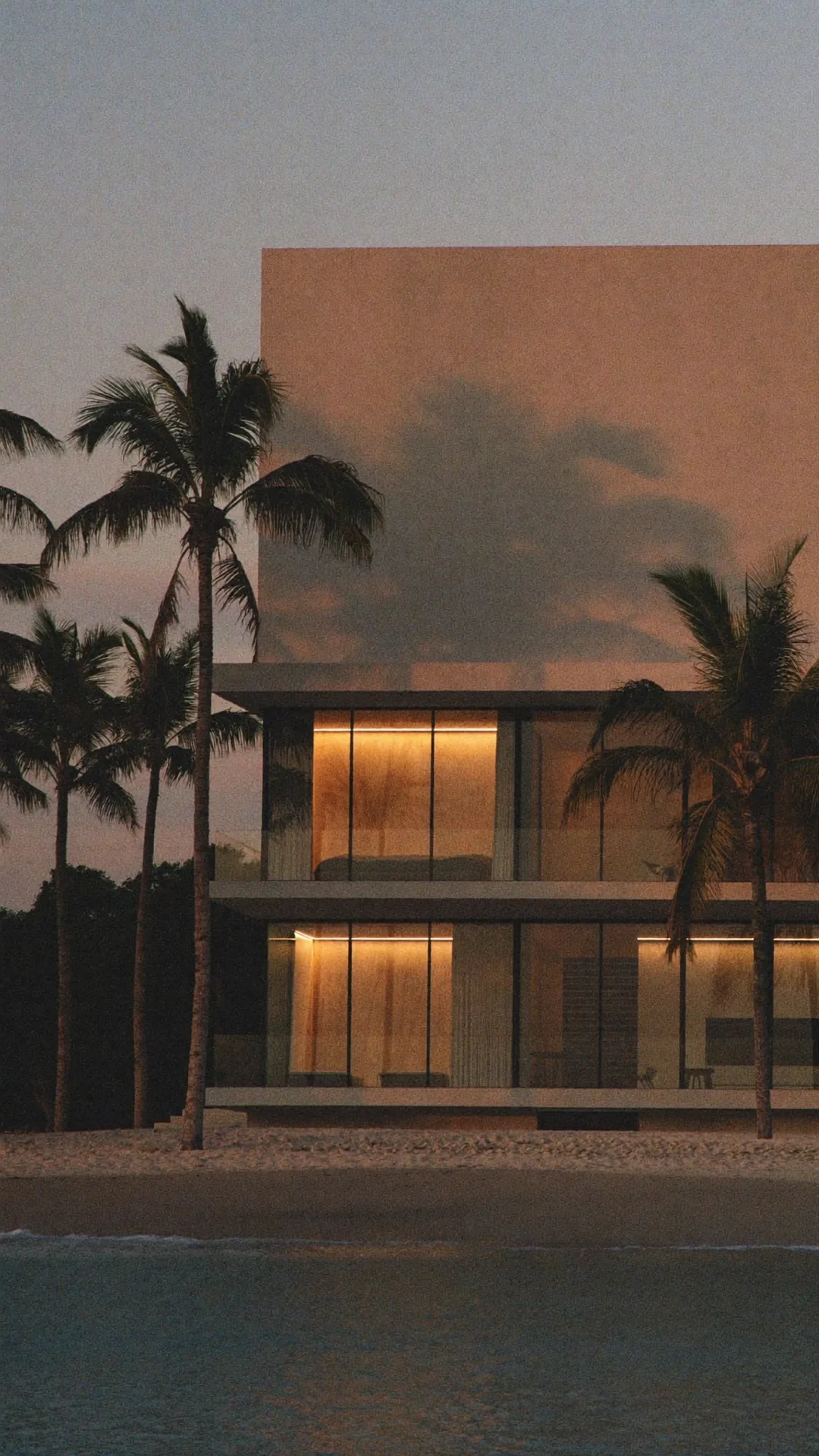 A contemporary beach house at dusk with warm interior light, AI-generated brand imagery