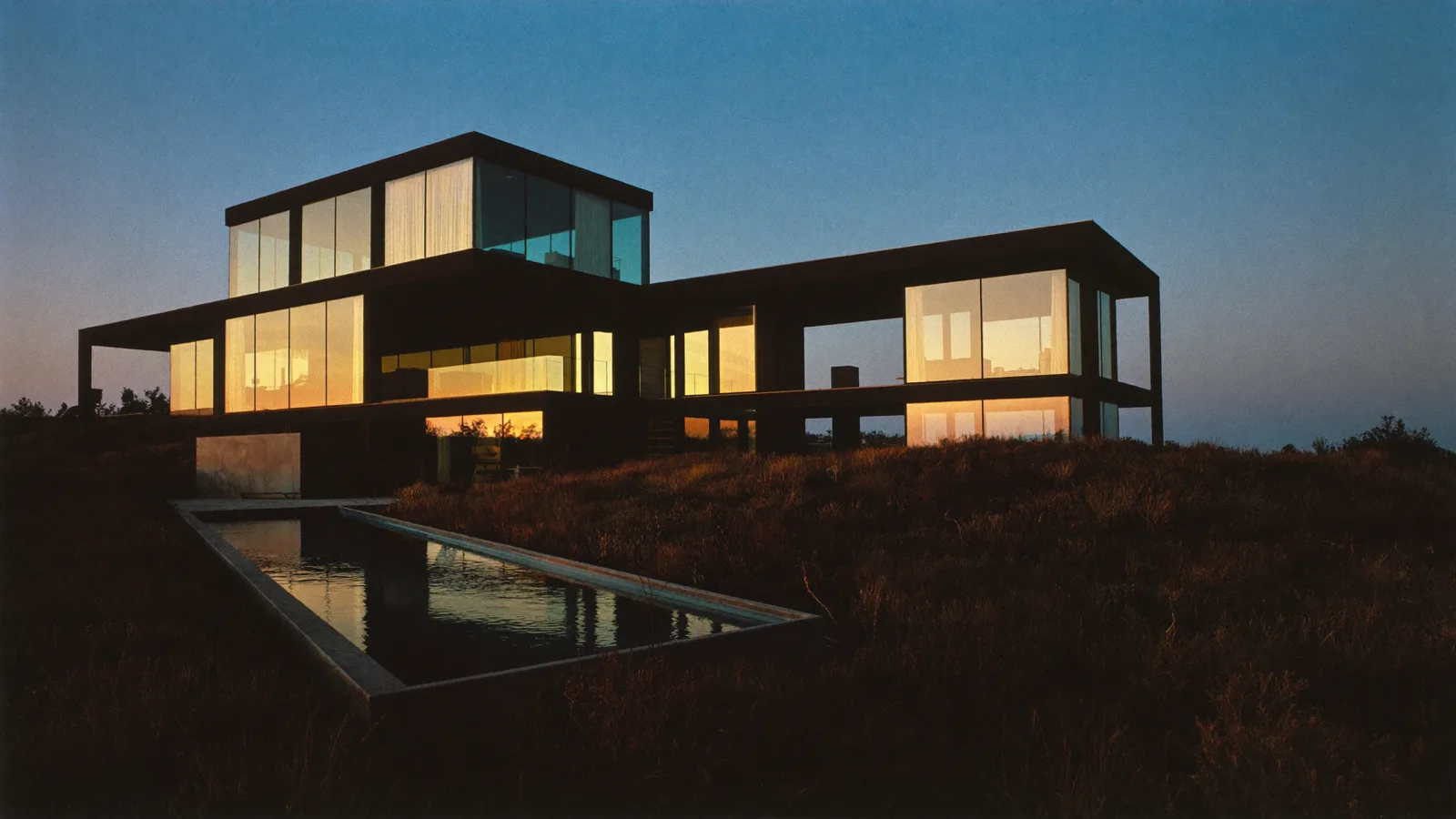 Villa exterior at blue hour, AI-generated VividProp brand imagery